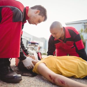 paramedics-examining-injured-woman paramedics-examining-injured-woman